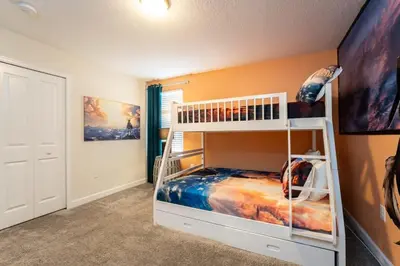 a bedroom with a bunk bed in a room at Magical 9BR Villa by Disney w Pool Theme Room in Kissimmee
