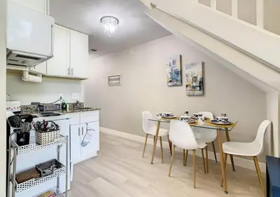 a kitchen and dining room with a table and chairs at Charming Lakeview Retreat III in Orlando