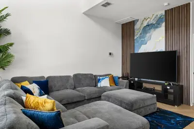 a living room with a couch and a flat screen tv at The Dream Vacation Home! in Orlando