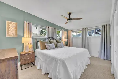 a bedroom with a bed and a ceiling fan at Best of Both Worlds Lakehouse in Orlando
