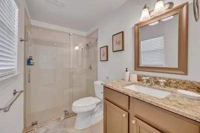 a bathroom with a toilet and a sink and a shower at Best of Both Worlds Lakehouse in Orlando