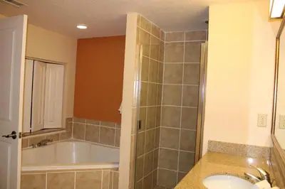 a bathroom with a tub and a sink at Floriday Resort in Orlando