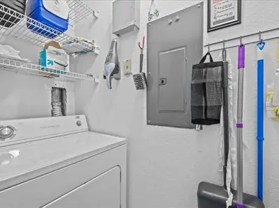 a bathroom with a sink and a washing machine at Theme Park Paradise! in Kissimmee