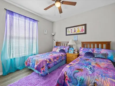 a bedroom with two beds and a ceiling fan at Theme Park Paradise! in Kissimmee