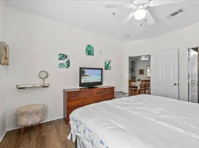 a bedroom with a bed and a television on a dresser at Theme Park Paradise! in Kissimmee