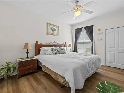 a bedroom with a bed and a ceiling fan at Theme Park Paradise! in Kissimmee