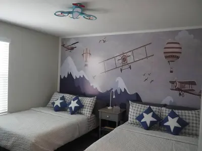 a bedroom with two beds and a mountain mural at Luxurious Farm Style House in Kissimmee