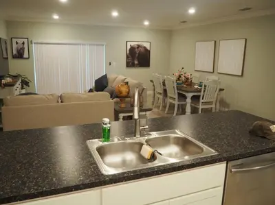 a kitchen with a sink and a living room at Luxurious Farm Style House in Kissimmee