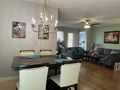 a dining room and living room with a table and chairs at Vista Cay Hideway Luxury Home By Universal Orlando in Orlando
