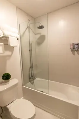 a bathroom with a shower and a toilet and a tub at A & S Vacation Rooms in Kissimmee