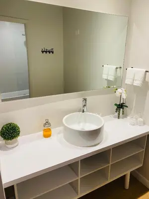 a bathroom with a sink and a large mirror at A & S Vacation Rooms in Kissimmee