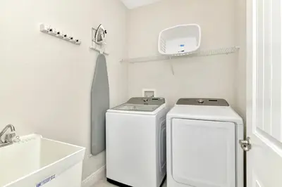 a bathroom with two washing machines and a sink at Modern Home With Private Pool, Ping Pong Table Near Disney With Waterpark & Resort Access At Encore Resort - 7758Wl in Kissimmee