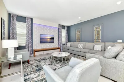 a living room with a couch and a table at Modern Home With Private Pool, Ping Pong Table Near Disney With Waterpark & Resort Access At Encore Resort - 7758Wl in Kissimmee