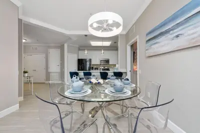 a dining room with a glass table and chairs at Orlando Resort: 3BD and electric fireplace in Orlando
