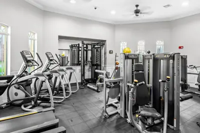 a gym with rows of exercise bikes and treadmills at Orlando Resort: 3BD and electric fireplace in Orlando