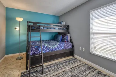 a bedroom with two bunk beds in a room at Charming 3BR home in Kissimmee with private pool and lake view, perfect for families. in Kissimmee