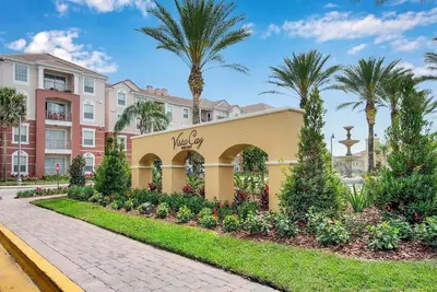a resort with palm trees and a building at Vista Cay Jewel Luxury By Universal Orlando Rental in Orlando