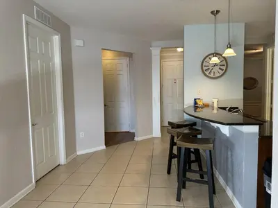 a kitchen with a counter and a clock on the wall at Vista Cay Jewel Luxury By Universal Orlando Rental in Orlando