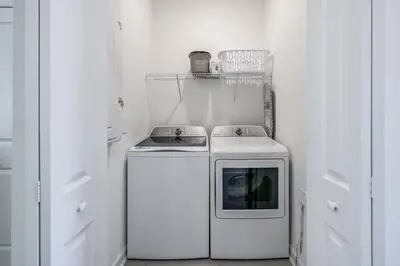 a white kitchen with a stove and a microwave at Opulent Retreat Themed Bedrooms and Pool Paradise in Kissimmee