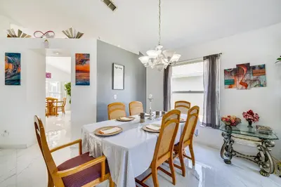a dining room with a table and chairs at Kissimmee Vacation Rental with Pool about 6 Mi to Disney in Kissimmee