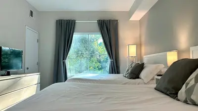 a bedroom with two beds and a window at HSO - Family Apartments Close to Disney World & Universal in Orlando