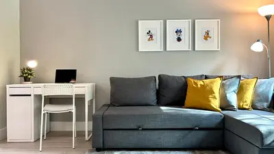 a living room with a couch and a desk at HSO - Family Apartments Close to Disney World & Universal in Orlando