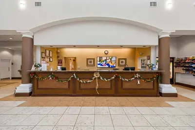 a lobby with a counter with christmas decorations at HSO - Family Apartments Close to Disney World & Universal in Orlando