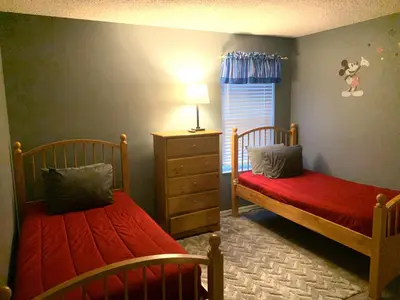 a bedroom with two beds and a window at Complete Vacation in exclusive 7 Bed resort home, in Kissimmee