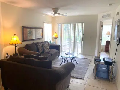 a living room with two couches and a table at Family Friendly Community in Kissimmee