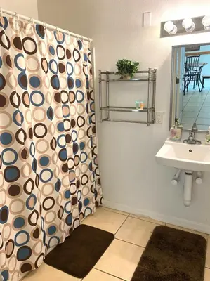a bathroom with a shower curtain and a sink at Family Friendly Community in Kissimmee