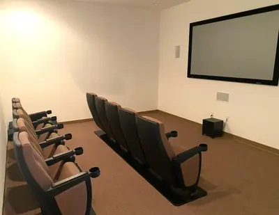 a row of chairs in a room with a screen at Family Friendly Community in Kissimmee