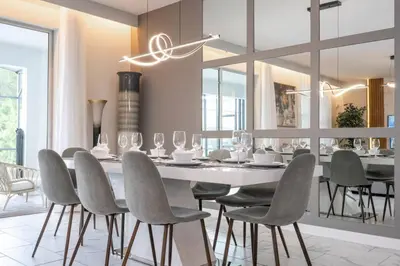 a dining room with a table and chairs at Lakeview 7Br W pool Disney area in Kissimmee