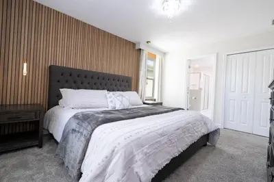 a bedroom with a large bed and a window at Lakeview 7Br W pool Disney area in Kissimmee