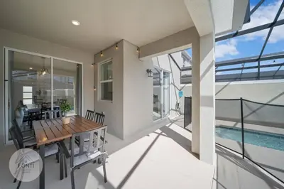 a dining room with a table and a swimming pool at BRAND NEW 4BR House Waterpark Disney Orlando 2697 in Kissimmee