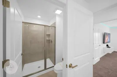 a white bathroom with a shower and a toilet at BRAND NEW 4BR House Waterpark Disney Orlando 2697 in Kissimmee