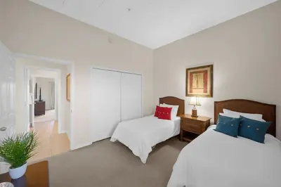 a bedroom with two beds and a table with a plant at Caribe Cove Resort 3BR Condo Apt Disney Orlando in Kissimmee