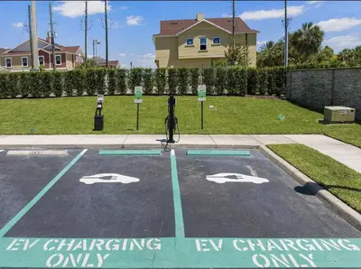 a parking lot with a car charging only sign in a yard at Awesome 4 beds Villa 5 min to Disney in Orlando