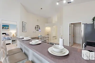 a kitchen and living room with a large counter top at Star Oasis at Citrus Ridge by Shine Villas 091 villa in Orlando