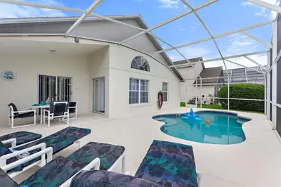 a patio with a pool with chairs and a table at Star Oasis at Citrus Ridge by Shine Villas 091 villa in Orlando
