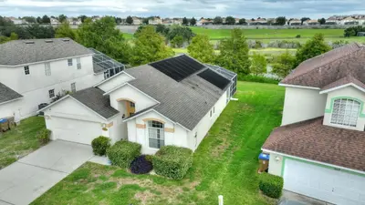 an aerial view of a house with solar panels on its roof at Star Oasis at Citrus Ridge by Shine Villas 091 villa in Orlando