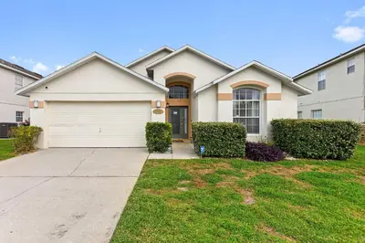 a white house with a garage at Star Oasis at Citrus Ridge by Shine Villas 091 villa in Orlando