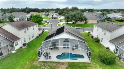 an aerial view of a home with a glass house at Star Oasis at Citrus Ridge by Shine Villas 091 villa in Orlando