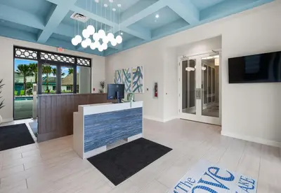 a living room with blue ceilings and a tv at Beautiful Apartments 5 Minutes away from Disney! in Kissimmee