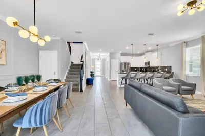 a dining room and living room with a table and chairs at Luxury Incredible Themed Home best vacation in Kissimmee