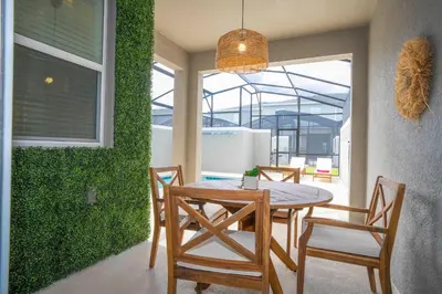 a dining room with a table and chairs at Magnificient 4Bd w Pool @ Storey Lake Resort 2648 in Kissimmee