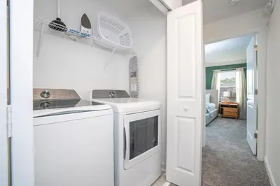 a kitchen with a washer and dryer in a room at Magnificient 4Bd w Pool @ Storey Lake Resort 2648 in Kissimmee