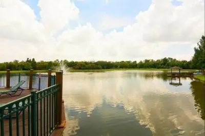 a view of a large lake with a bench at Awesome 3 beds Villa at Seven Dwarfs in Kissimmee