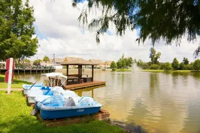 a group of boats parked at a dock on a lake at Awesome 3 beds Villa at Seven Dwarfs in Kissimmee