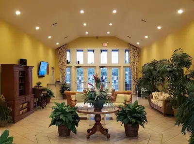 a lobby with potted plants and a table at Awesome 3 beds Villa at Seven Dwarfs in Kissimmee