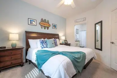 a bedroom with a bed and a dresser and a mirror at Marvelous 4 Bd Close To Disney at West Lucaya 8959 in Kissimmee